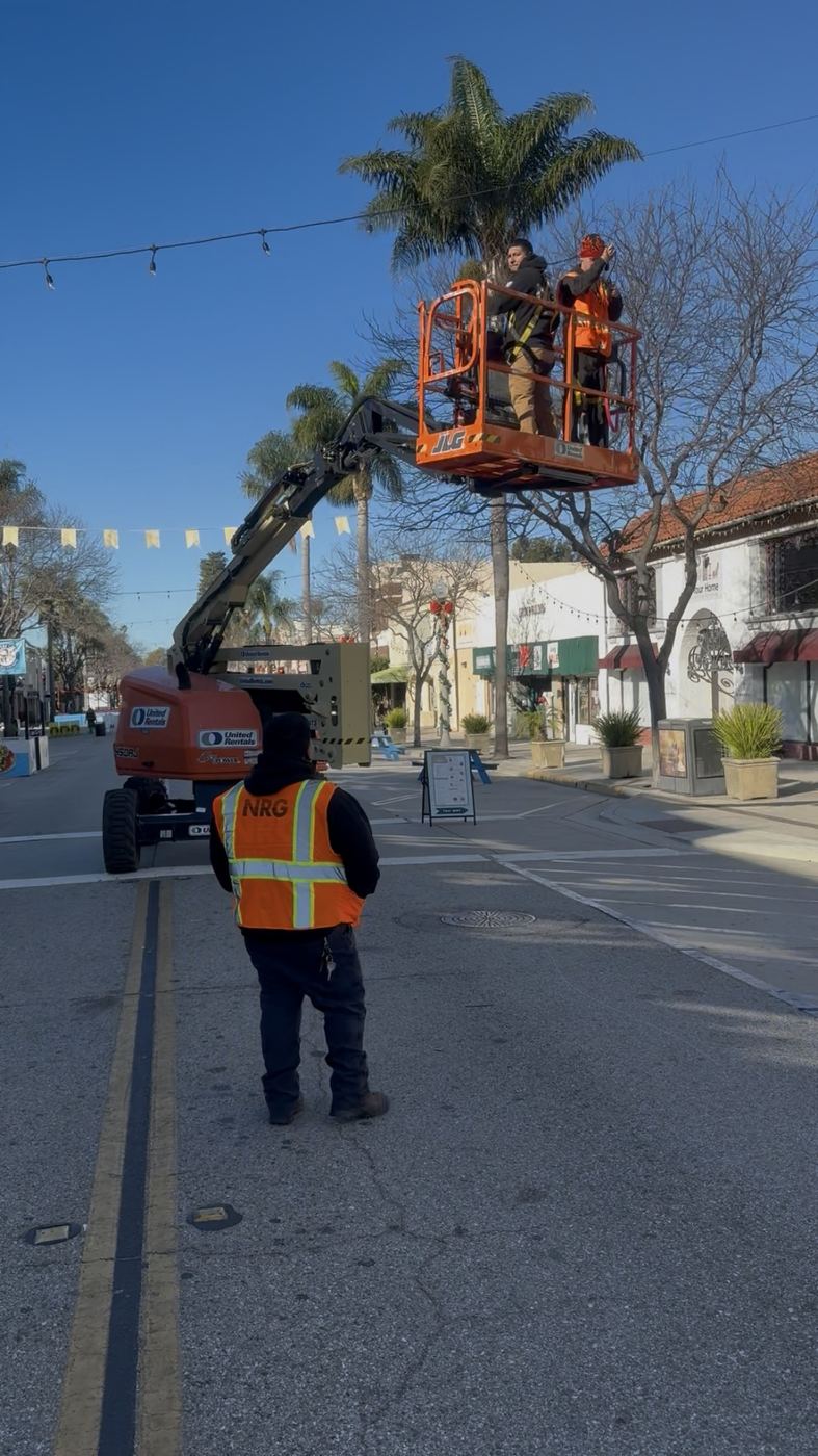 Boom lift at the palm tops for the downtown string-light run