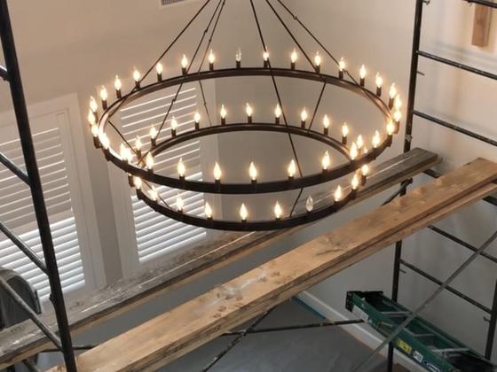 Two-story foyer ring chandelier installed from scaffold
