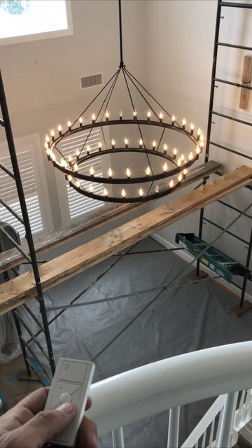 Two-story foyer ring chandelier installed from scaffold