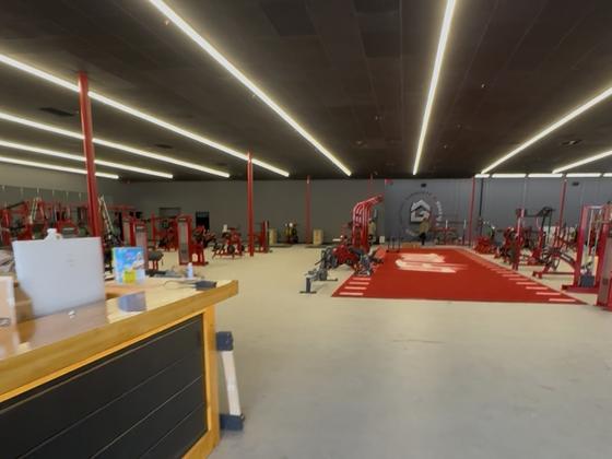 Completed gym tenant improvement with radiating linear LED lighting
