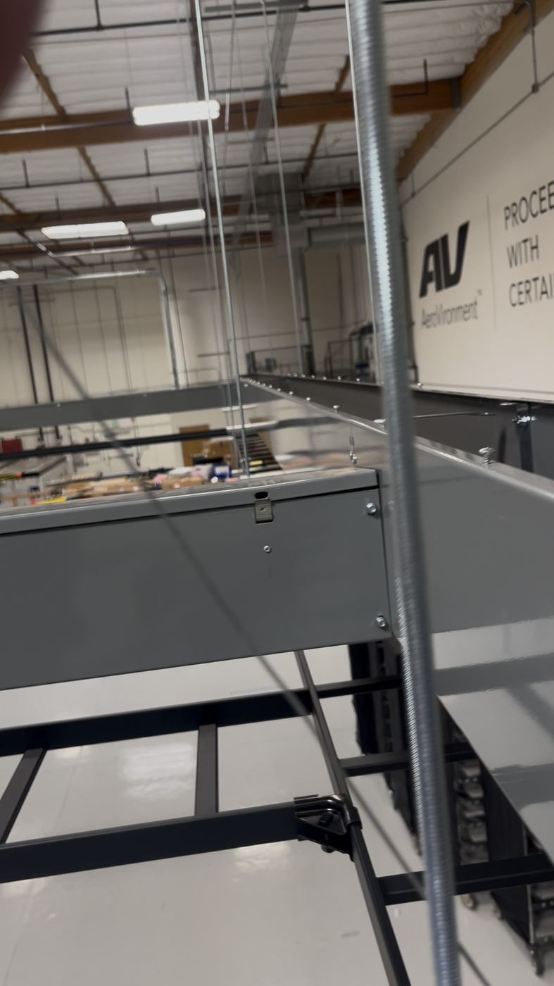 Industrial mezzanine/conveyor structure with strut and rod hangers