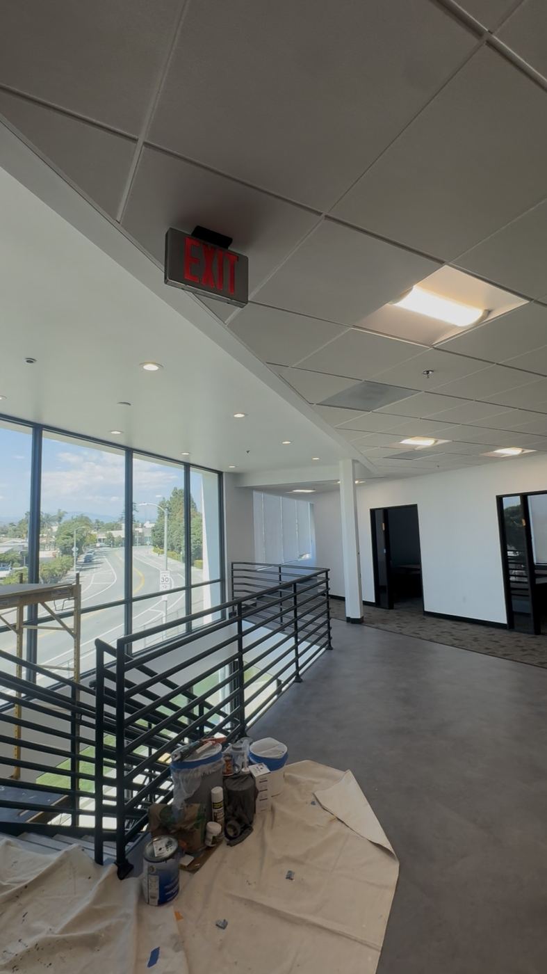 Office mezzanine with new steel railing, paint in progress