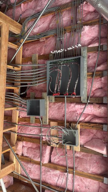 Wall of organized MC cable runs and junction boxes at rough-in