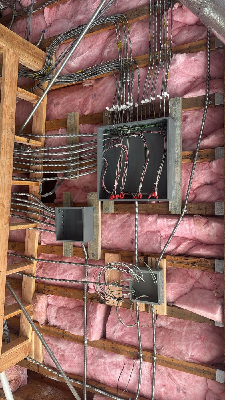 Wall of organized MC cable runs and j-boxes, rough-in
