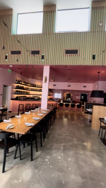 Finished restaurant tenant improvement with wine wall and slat mezzanine