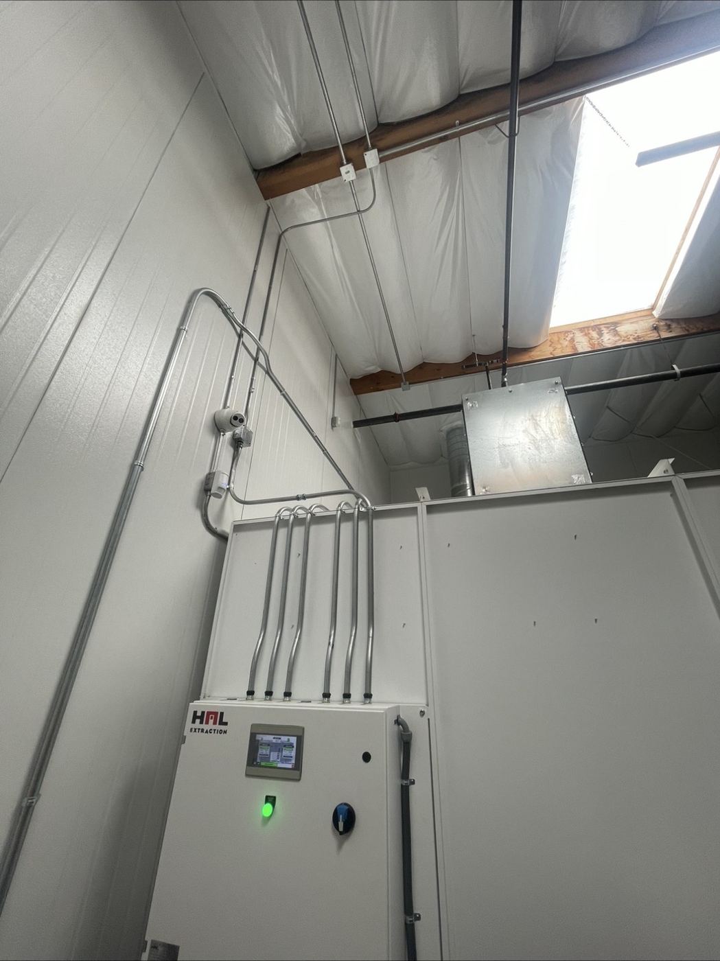 Warehouse control panel with clean conduit runs up the wall